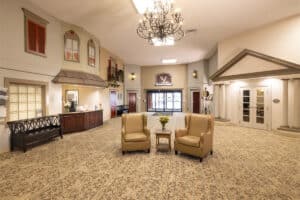 Front entrance with seating and chandelier at the Villages of Jackson Creek